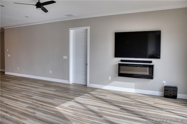 unfurnished living room featuring ceiling fan, ornamental molding, and light hardwood / wood-style floors