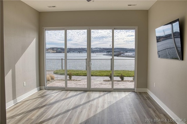 doorway to outside featuring a healthy amount of sunlight and wood-type flooring