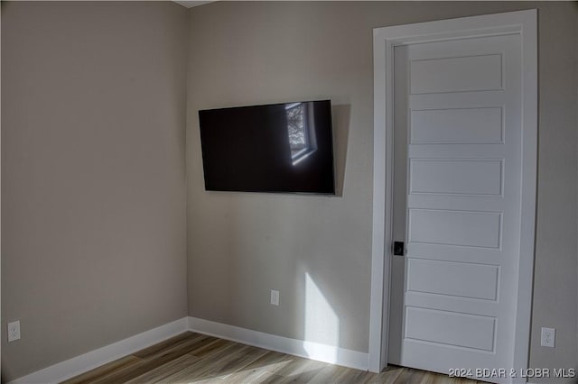 empty room with light hardwood / wood-style flooring