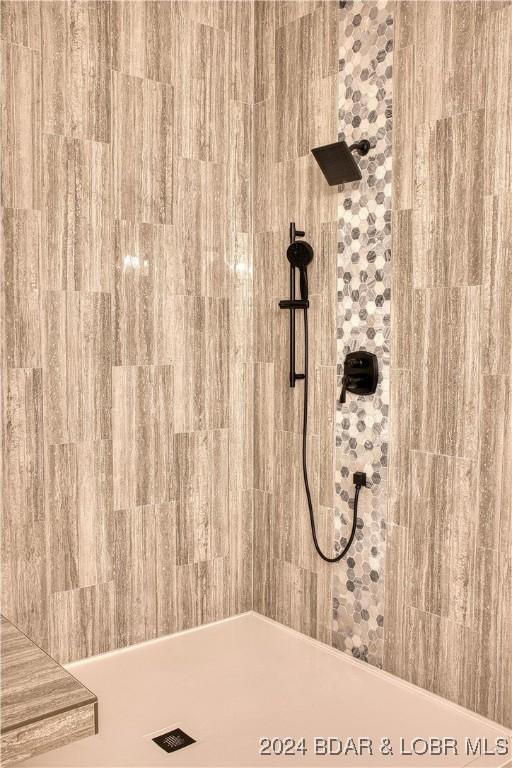 bathroom with tiled shower