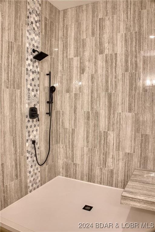 bathroom with tiled shower