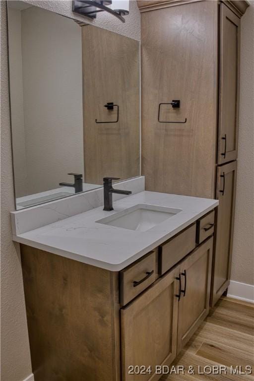 bathroom with vanity and hardwood / wood-style floors