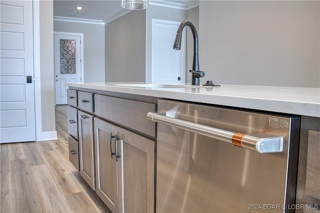 bathroom with sink, crown molding, and wood-type flooring