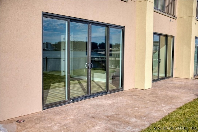 view of exterior entry featuring a patio area