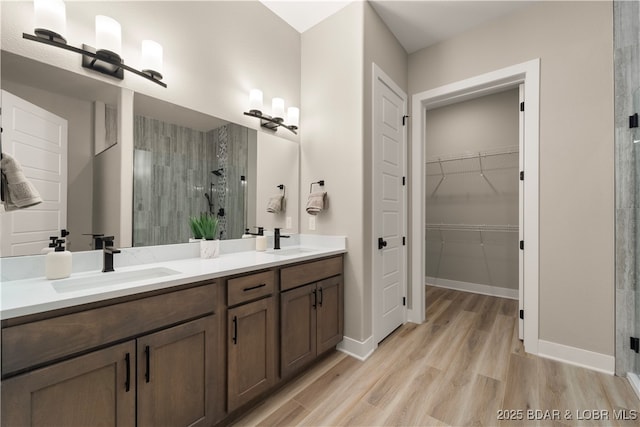 1184 Jeffries Rd Unit 519, Osage Beach, MO 65065 - full bath featuring a stall shower, wood finished floors, double vanity, and a spacious closet
