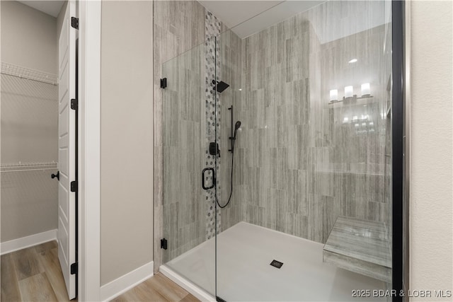 1184 Jeffries Rd Unit 519, Osage Beach, MO 65065 - bathroom featuring a stall shower, a spacious closet, and wood finished floors