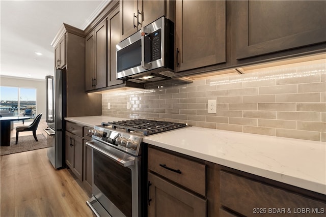 1184 Jeffries Rd Unit 519, Osage Beach, MO 65065 - kitchen featuring appliances with stainless steel finishes, light wood finished floors, dark brown cabinetry, backsplash, and recessed lighting