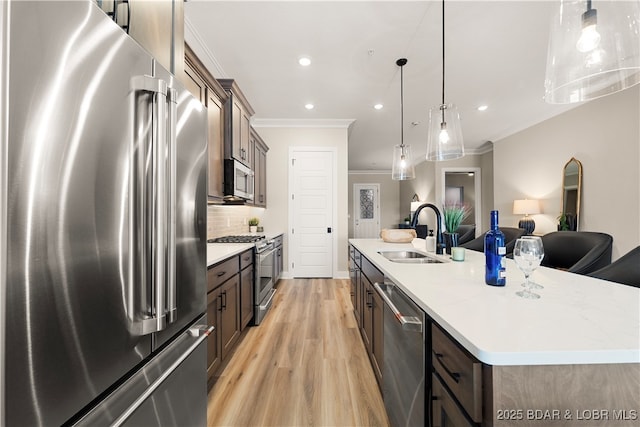 1184 Jeffries Rd Unit 519, Osage Beach, MO 65065 - kitchen featuring stainless steel appliances, crown molding, an island with sink, light wood-style flooring, and open floor plan