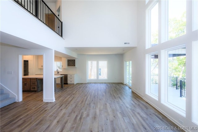 17023 Seminole Dr W, Rocky Mount, MO 65072 - unfurnished living room featuring a towering ceiling and wood finished floors