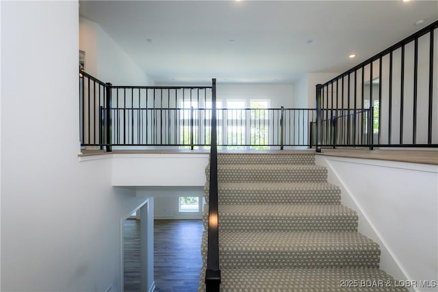 17023 Seminole Dr W, Rocky Mount, MO 65072 - stairs with healthy amount of natural light, wood finished floors, and recessed lighting