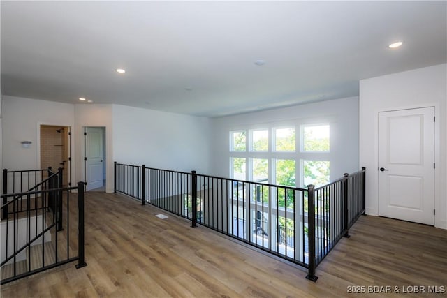 17023 Seminole Dr W, Rocky Mount, MO 65072 - corridor with an upstairs landing, wood finished floors, and recessed lighting