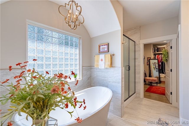 bathroom with lofted ceiling, separate shower and tub, and an inviting chandelier