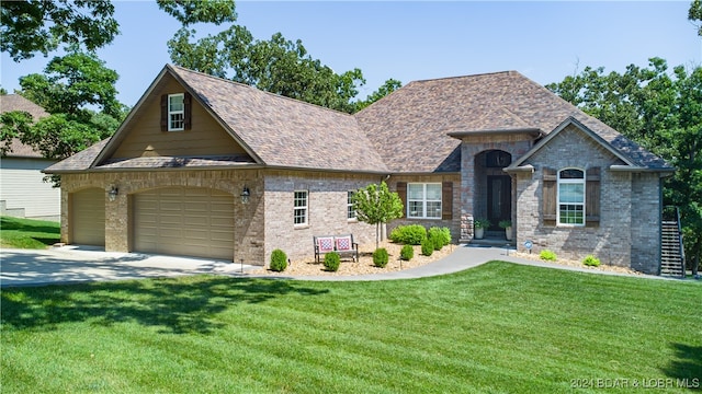 view of front of home featuring a front lawn and a garage