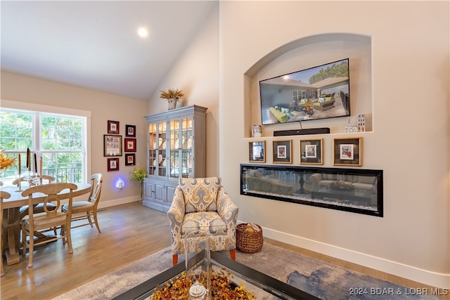 sitting room featuring lofted ceiling and light hardwood / wood-style floors