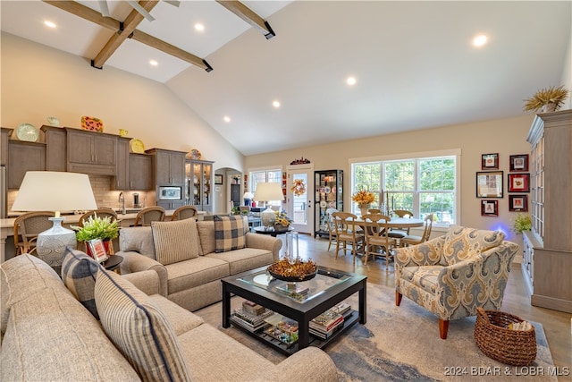 living room featuring high vaulted ceiling, beamed ceiling, and wood-type flooring