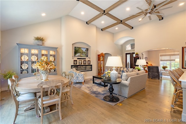 dining space featuring high vaulted ceiling, ceiling fan, and light hardwood / wood-style floors