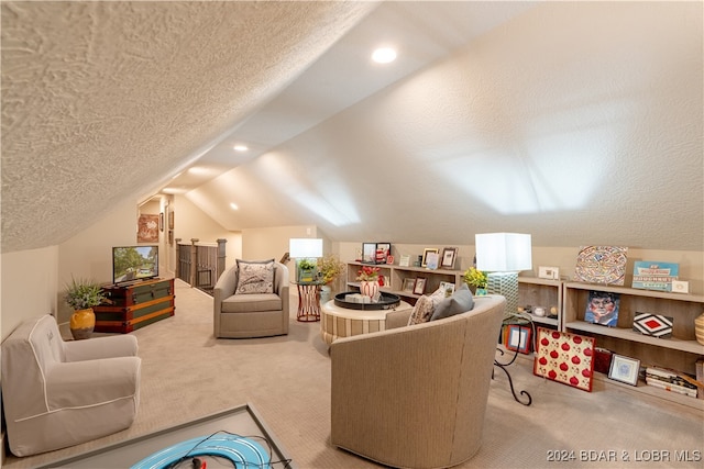 living room with lofted ceiling, carpet flooring, and a textured ceiling