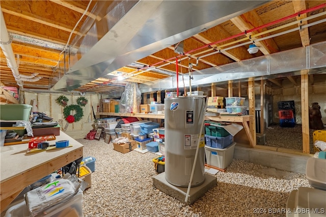 basement featuring water heater and carpet floors