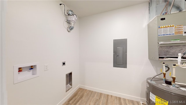 clothes washing area with water heater, light hardwood / wood-style flooring, hookup for a washing machine, hookup for an electric dryer, and electric panel