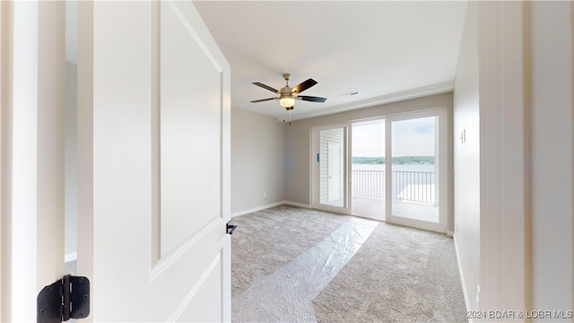 spare room with light carpet and ceiling fan