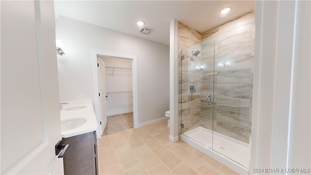 bathroom featuring vanity, tile patterned flooring, toilet, and an enclosed shower