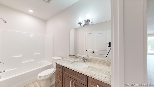 full bathroom with toilet, vanity, and  shower combination