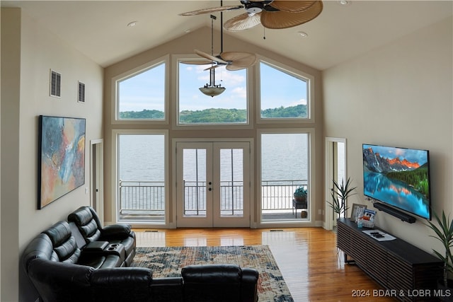 living room featuring french doors, ceiling fan, high vaulted ceiling, and hardwood / wood-style flooring