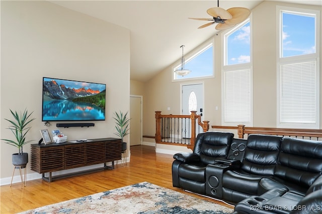 living room with light wood-type flooring, high vaulted ceiling, and ceiling fan