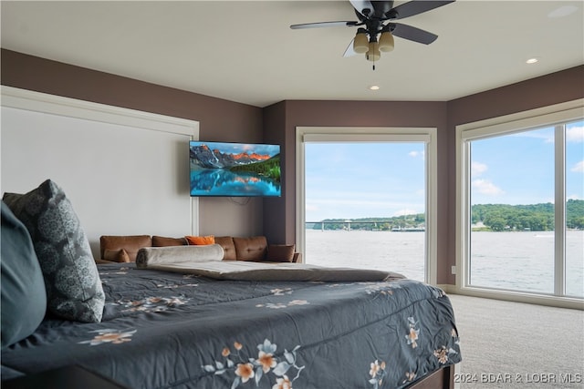 carpeted bedroom with ceiling fan and access to outside