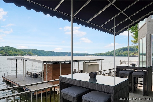 wooden deck featuring a water view and a dock