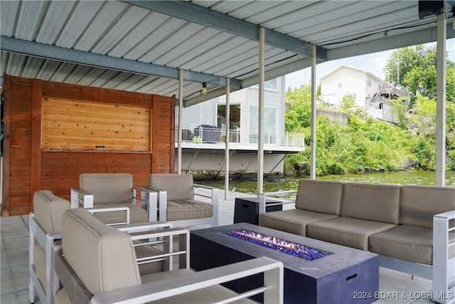 view of patio featuring an outdoor living space with a fire pit