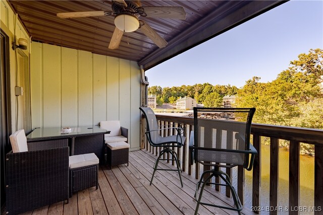 wooden terrace featuring ceiling fan