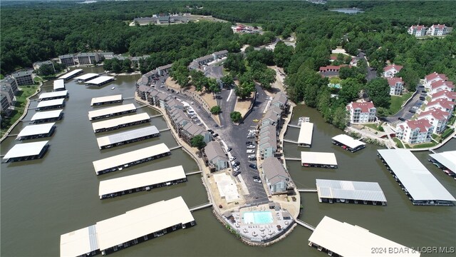 aerial view with a water view and a wooded view