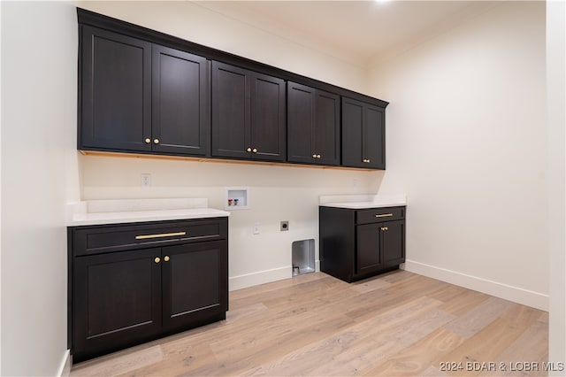 laundry room with washer hookup, cabinets, light wood-type flooring, and hookup for an electric dryer