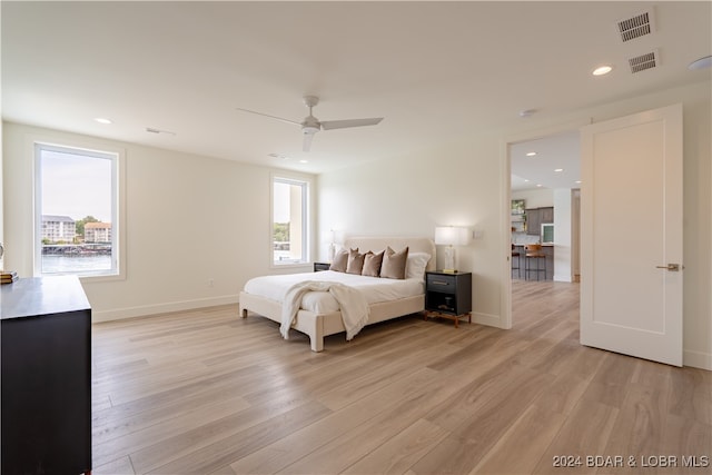 bedroom with ceiling fan and light hardwood / wood-style flooring