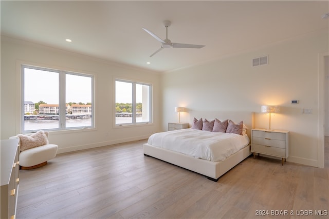 bedroom with ceiling fan, light wood-type flooring, and ornamental molding