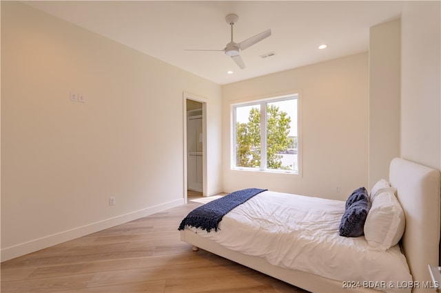 bedroom with light wood-type flooring and ceiling fan