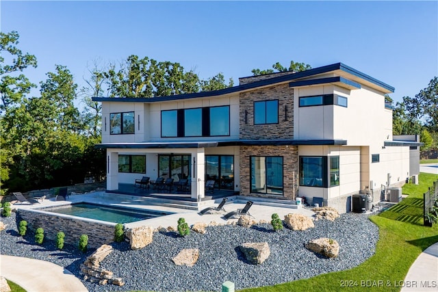 back of house featuring cooling unit and a patio area