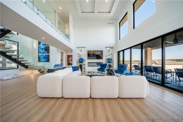 living room with a high ceiling and hardwood / wood-style floors