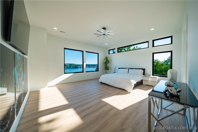 bedroom featuring light wood-type flooring and multiple windows