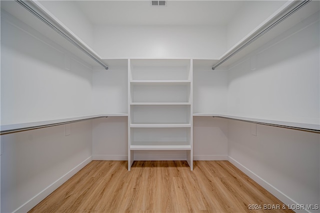 walk in closet with light wood-type flooring