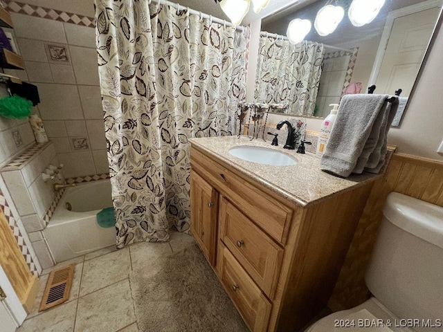 full bathroom with shower / bath combo with shower curtain, toilet, and vanity