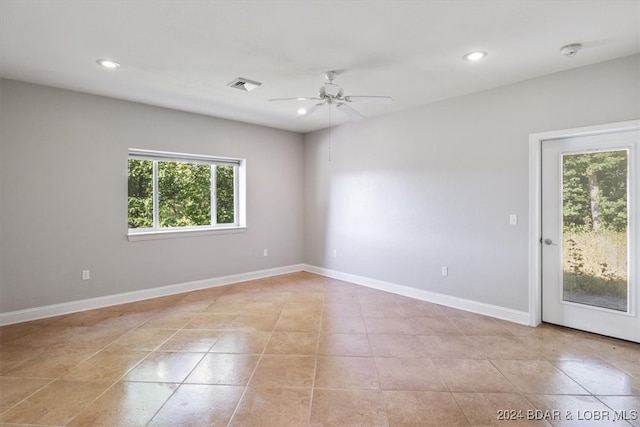 tiled empty room with ceiling fan