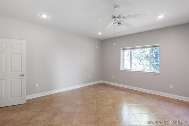 empty room featuring light tile patterned floors and ceiling fan