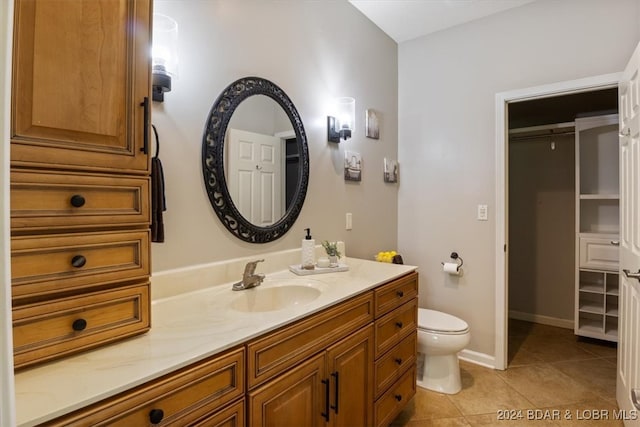 bathroom with vanity, toilet, and tile patterned flooring