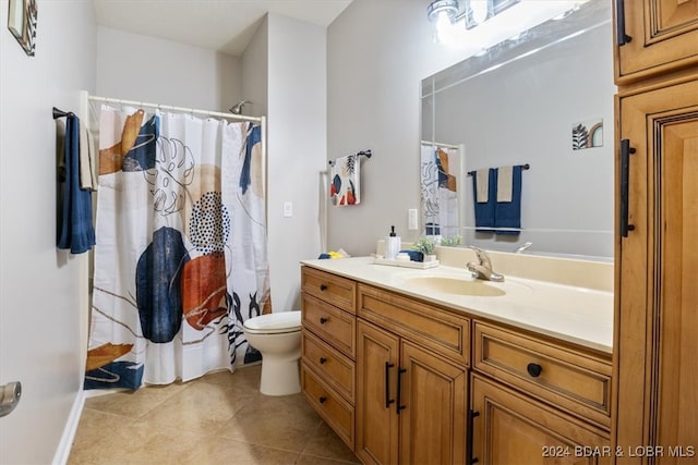 bathroom featuring tile patterned flooring, vanity, toilet, and a shower with curtain