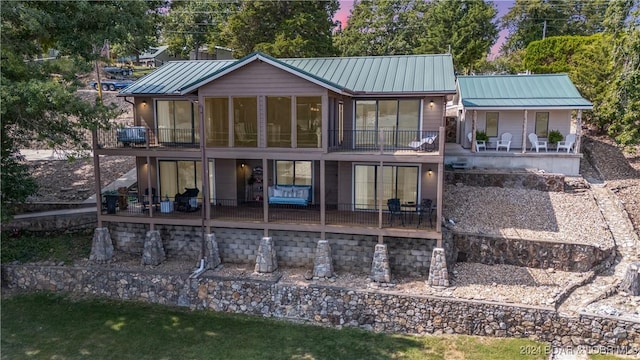 back of house featuring a balcony and a patio area