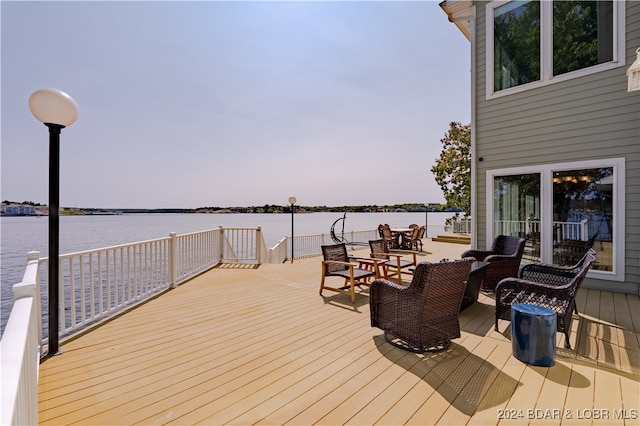 wooden terrace featuring a water view