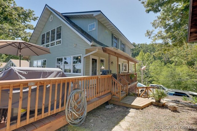 back of property featuring a wooden deck