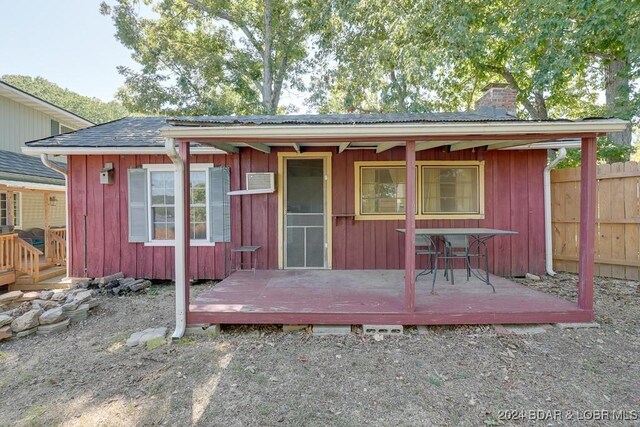 rear view of property featuring a deck